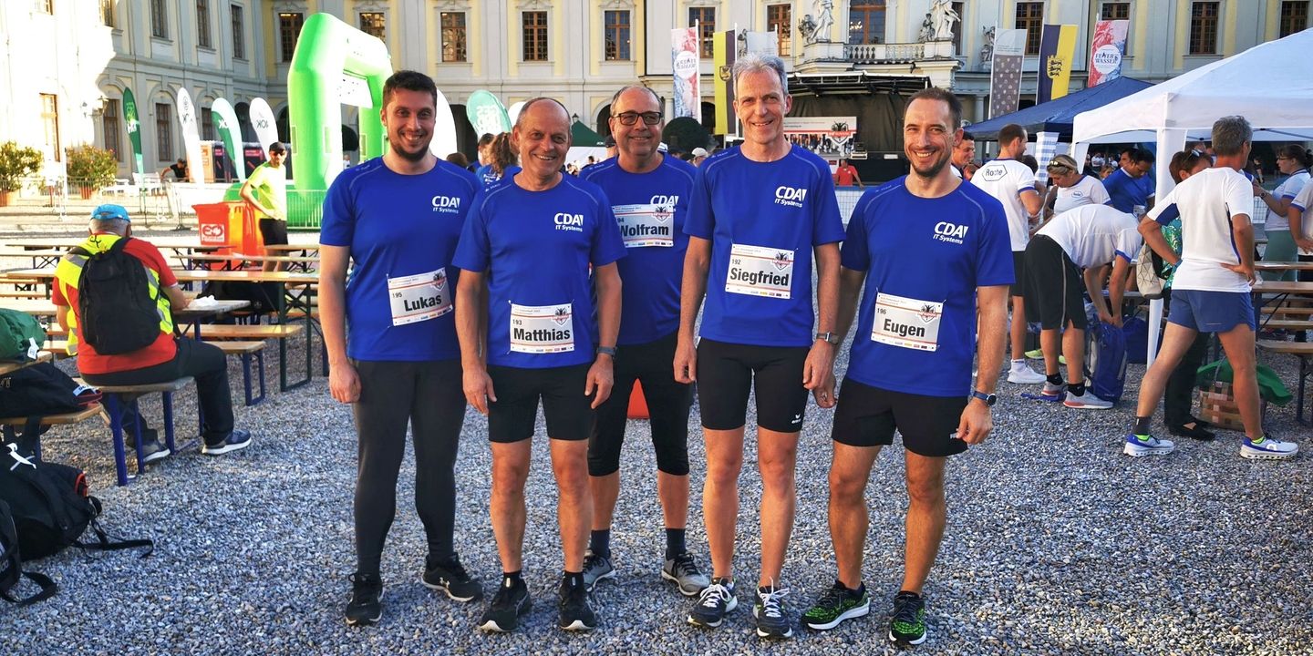 5 men with a blue top and a start number on their chest